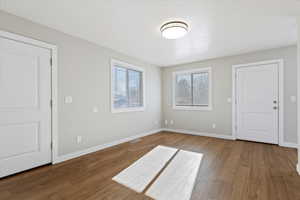 Spare room featuring baseboards and hardwood / wood-style flooring