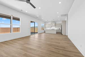 Unfurnished living room featuring light wood-type flooring, recessed lighting, and ceiling fan