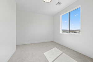 Empty room with light carpet and baseboards