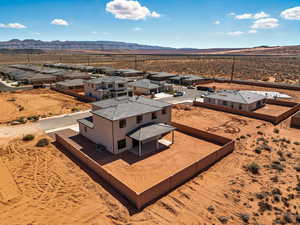 Aerial view of residential area with a mountainous background and a desert landscape