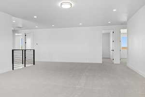 Unfurnished room featuring light carpet and recessed lighting