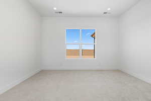 Unfurnished room featuring light carpet and recessed lighting