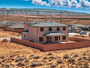 Back of house featuring a patio area, a residential view, a mountain view, and a fenced backyard