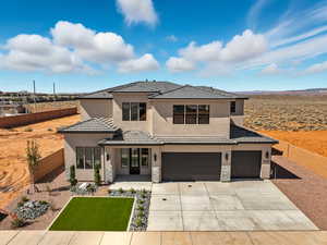 View of front of property featuring stucco siding, stone siding, driveway, an attached garage, and a tiled roof