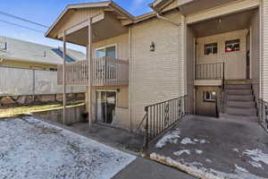 View of exterior entry featuring brick siding