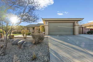 View of front of property with driveway, stucco siding, and a garage