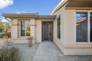 Entrance to property featuring stucco siding