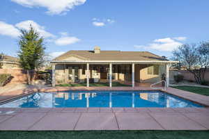 View of pool with a fenced backyard and a patio