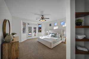 Carpeted bedroom featuring access to exterior, french doors, and ceiling fan