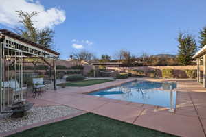 View of pool with a patio area, a fenced backyard, and a gazebo