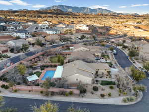 Aerial perspective of suburban area with a mountain backdrop and a pool area