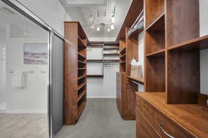 Spacious closet with carpet and tile patterned floors