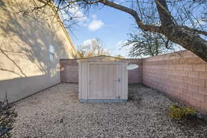 View of shed featuring a fenced backyard