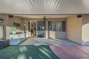 View of patio with a ceiling fan and area for grilling