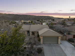 View of front of property with a tile roof, driveway, a garage, a mountain view, and a gate
