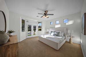 Carpeted bedroom featuring access to exterior and a ceiling fan