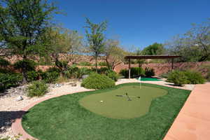View of home's community featuring a putting green