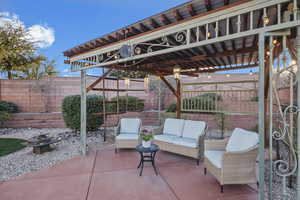 Fenced backyard with outdoor lounge area and a patio