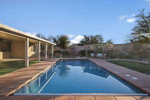View of pool with a patio and a fenced backyard