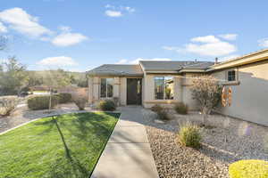View of front of home with stucco siding and a tile roof
