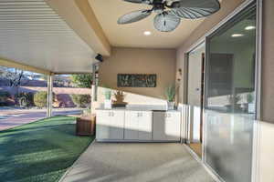 View of patio featuring an outdoor kitchen and ceiling fan