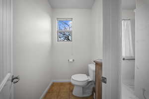 Bathroom featuring light tile patterned flooring and a shower