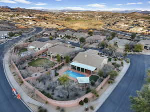 Aerial overview of property's location featuring nearby suburban area and a mountainous background