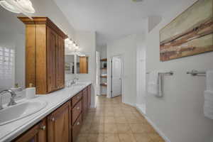 Bathroom featuring double vanity and light tile patterned flooring