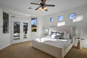 Bedroom featuring access to exterior, carpet, and multiple windows