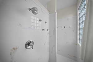 Bathroom featuring a marble finish shower