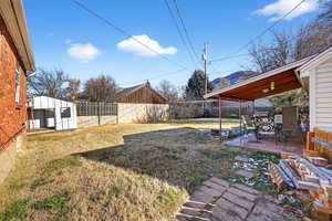 Fenced backyard featuring a garage, a patio area, and outdoor dining space