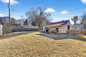 Fenced backyard with a patio area and garage