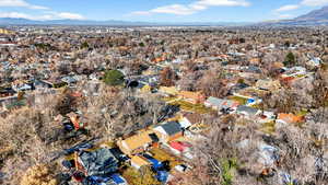 Aerial view of property's location featuring nearby suburban area and a mountainous background
