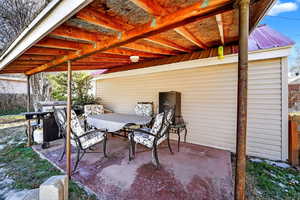 View of patio with grilling area and outdoor dining area