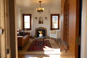 Living area featuring a chandelier and wood finished floors