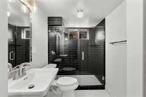 Bathroom with a shower stall and tile patterned flooring
