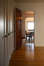 Corridor with arched walkways and dark wood-style floors