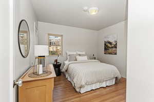 Bedroom featuring light wood-style flooring and ornamental molding
