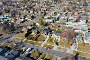 Aerial view of property and surrounding area with nearby suburban area