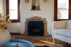 Living area with wood finished floors and a fireplace