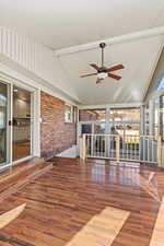 Unfurnished sunroom featuring lofted ceiling and healthy amount of natural light