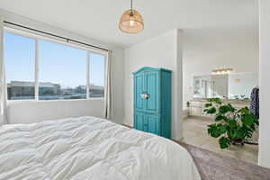 Bedroom featuring light tile patterned floors and a textured ceiling