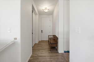 Corridor with wood finished floors and baseboards