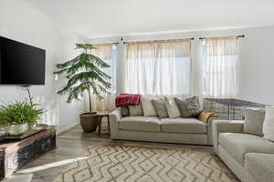 Living area with wood finished floors and baseboards