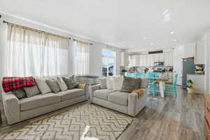 Living room featuring wood finished floors and recessed lighting