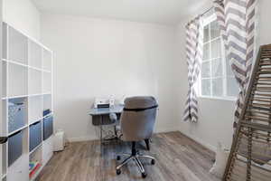Office area featuring wood finished floors and baseboards