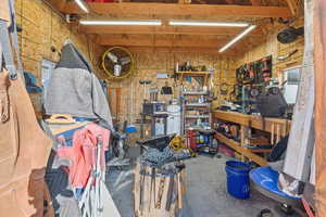 Miscellaneous room with a workshop area and concrete flooring