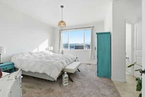 Carpeted bedroom with a textured ceiling and tile patterned floors