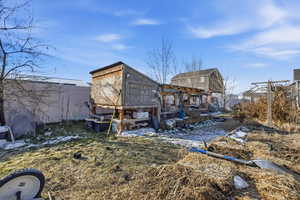 Back of property featuring exterior structure and an outdoor structure