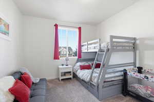 Carpeted bedroom featuring baseboards